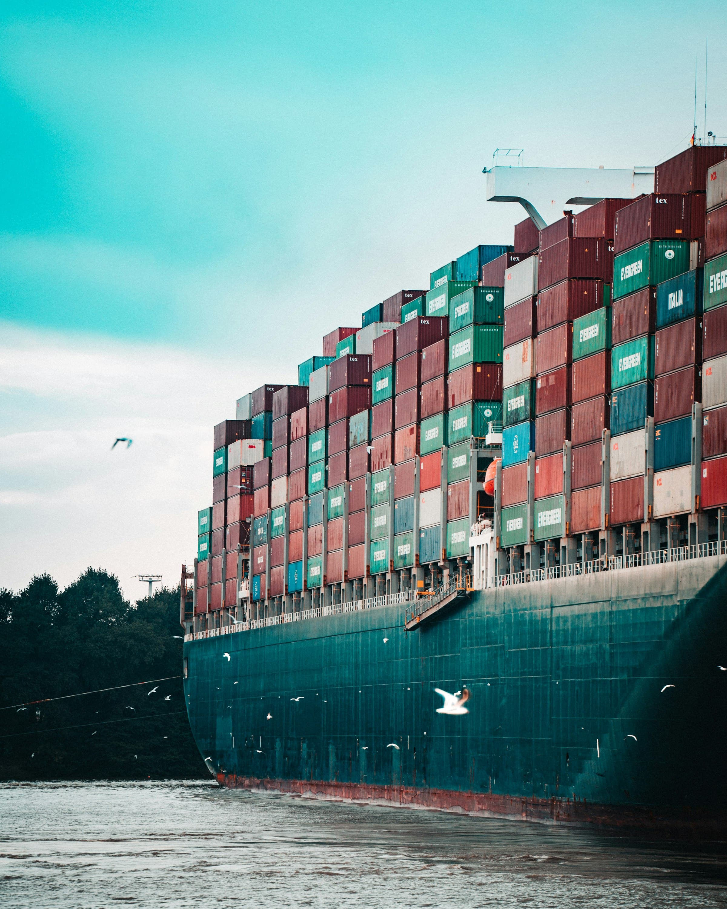 Cargo ship at an industrial port, loaded for export